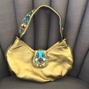 Donald J Pliner gold bag with sequence detail.
